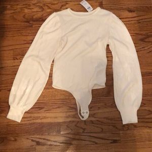 Cream colored long sleeve body suit sweater